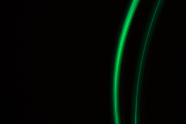 green  light lines on a black background - Foto, Imagen