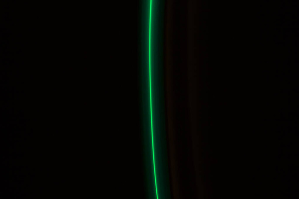 green  light lines on a black background - Foto, Imagem