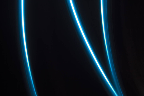 blue  light lines on a black background - Foto, Imagem
