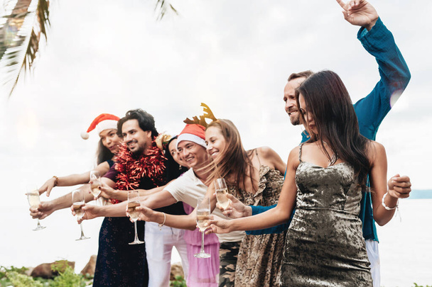 Friends celebrating Christmas or New Year eve at the beach. - Photo, Image