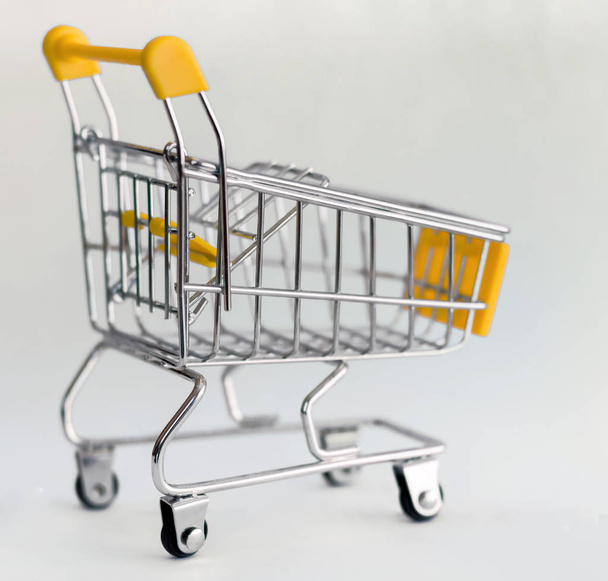  Shopping cart close-up. Isolated. Sales - Zdjęcie, obraz
