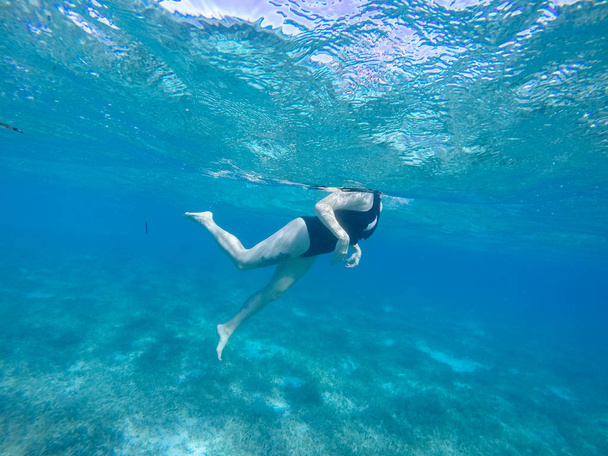 Diving in the red sea. Sexy girl in bikini and mask. Snorkeling. - Zdjęcie, obraz