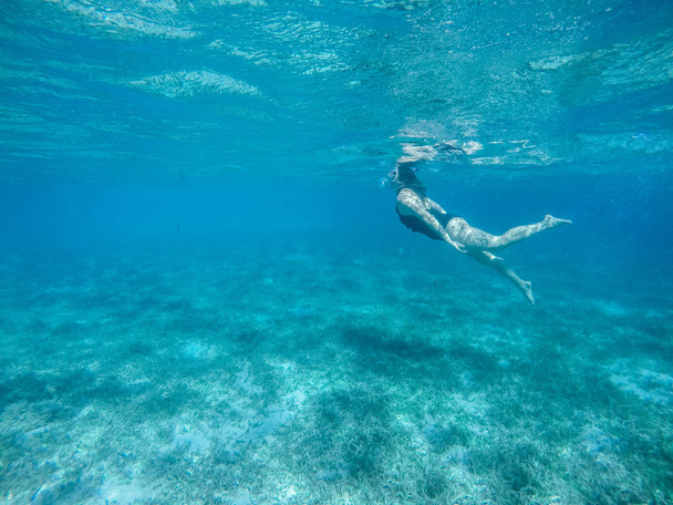 Diving in the red sea. Sexy girl in bikini and mask. Snorkeling. - Zdjęcie, obraz