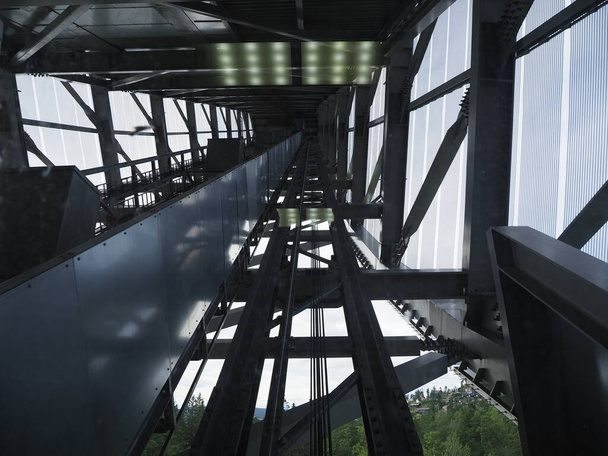 Inside construction of ski jump elevator in Holmenkollen near european capital city of Oslo in Norway, cloudy sky in 2019 cold summer day on July. - Photo, image