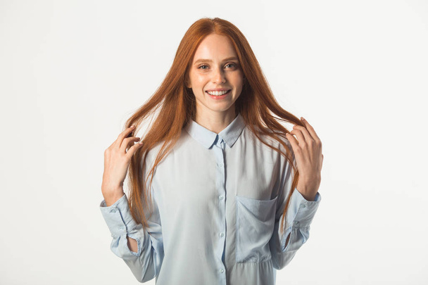 beautiful young woman with red hair on a white background - Zdjęcie, obraz