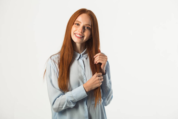 beautiful young woman with red hair on a white background - Valokuva, kuva