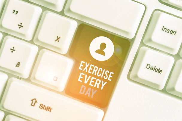 Writing note showing Exercise Every Day. Business photo showcasing move body energetically in order to get fit and healthy White pc keyboard with note paper above the white background. - Photo, Image