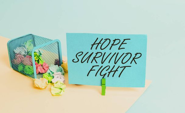 Writing note showing Hope Survivor Fight. Business photo showcasing stand against your illness be fighter stick to dreams Trash bin crumpled paper clothespin reminder office supplies. - Photo, Image