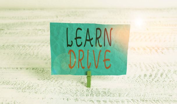Word writing text Learn Drive. Business concept for to gain the knowledge or skill in driving a motor vehicle Green clothespin white wood background colored paper reminder office supply. - Photo, Image
