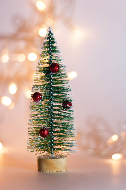 Small Christmas decorative fir tree isolated on a colorful background. Festive christmas background - Valokuva, kuva