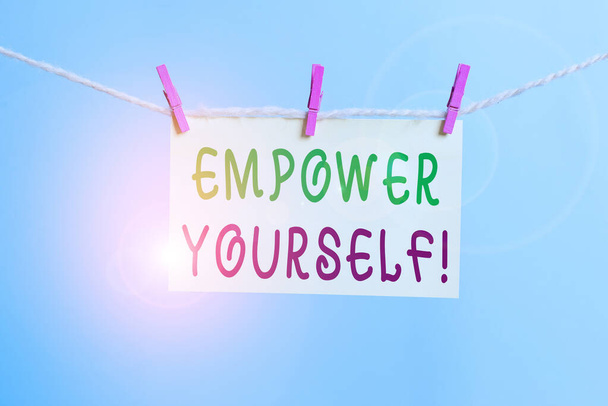 Word writing text Empower Yourself. Business concept for taking control of our life setting goals and making choices Clothesline clothespin rectangle shaped paper reminder white wood desk. - Photo, Image