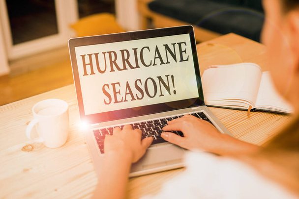 Word writing text Hurricane Season. Business concept for time when most tropical cyclones are expected to develop woman laptop computer smartphone mug office supplies technological devices. - Photo, Image