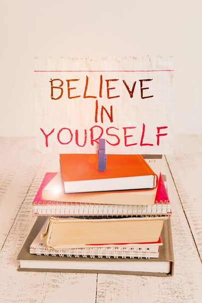 Conceptual hand writing showing Believe In Yourself. Business photo text common piece of advice that you can do everything pile stacked books notebook pin color reminder white wooden. - Foto, immagini