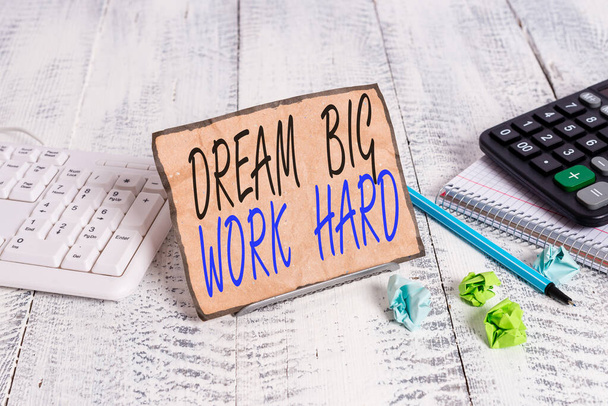 Writing note showing Dream Big Work Hard. Business photo showcasing Believe in yourself and follow the dreams and goals Notepaper on wire in between computer keyboard and sheets. - Photo, Image