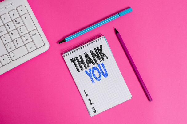 Conceptual hand writing showing Thank You. Business photo showcasing a polite expression used when acknowledging a gift or service Writing equipments and computer stuff placed on plain table. - Photo, Image