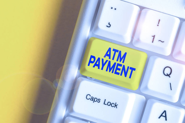 Writing note showing Atm Payment. Business photo showcasing Cashless Payment made through portable electronic devices White pc keyboard with note paper above the white background. - Photo, Image