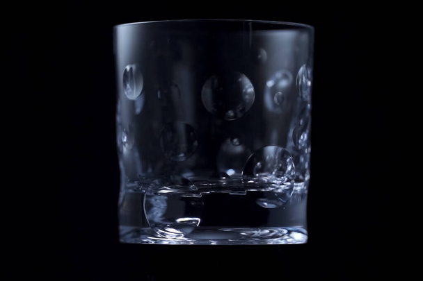Glas für Alkohol auf schwarzem Hintergrund. - Foto, Bild