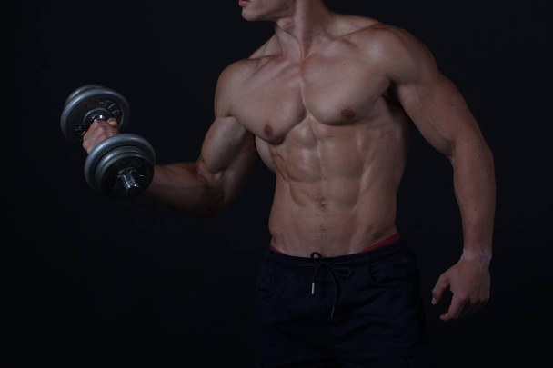 Muscular strong men on black background - Фото, зображення