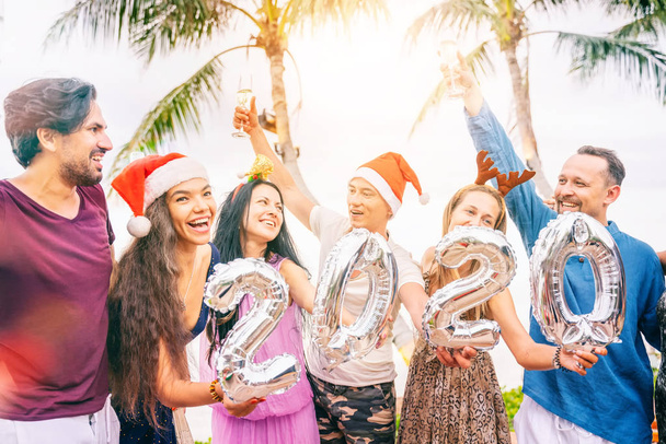 Group of happy people of mixed race friends celebrate Christmas  - Photo, Image