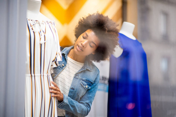 Portrait of beautiful young black woman shopping for clothes in store - Photo, Image