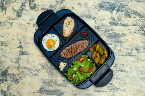 Breakfast, fried steak or cutlet, salad with tomato and green vegetables, toast, potato, egg top view, light background. The concept of healthy diet, diet, menu, good nutrition. - Photo, Image