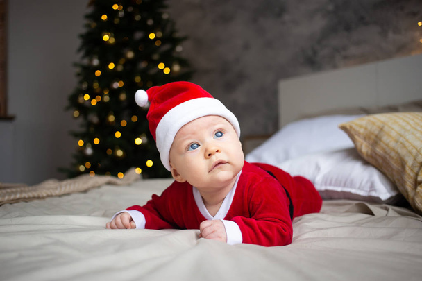 Amazed attractive baby boy in Christmas costume - Zdjęcie, obraz