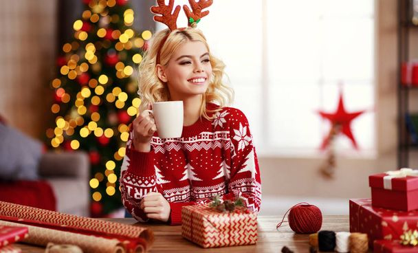 happy   girl gets ready for christmas and packs gift - 写真・画像