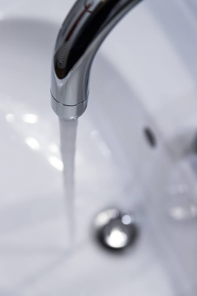 Close up of a water spigot in a clean bathroom. Water saving. - Фото, зображення