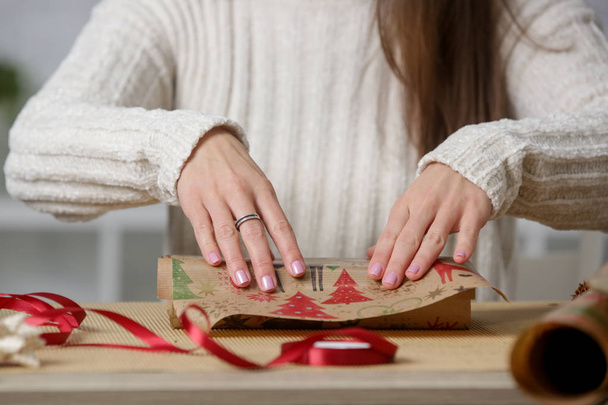 Woman wrapping Christmas presents, winter hoildays,  gifting season concept - Zdjęcie, obraz