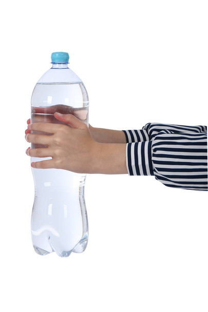 Hands holding a bottle of mineral water. - 写真・画像