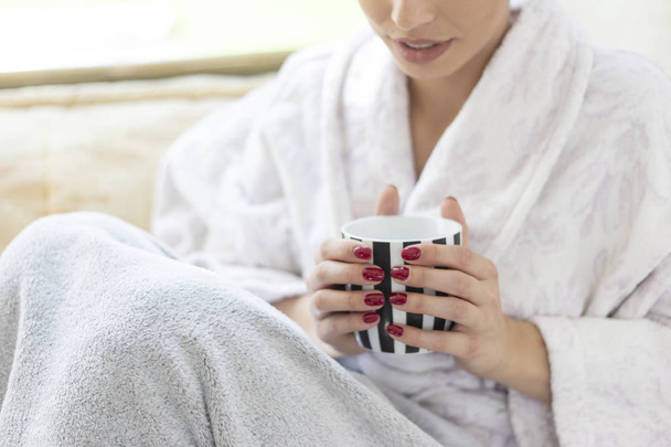 Cozy winter morning, woman hands holding teacup - Foto, afbeelding