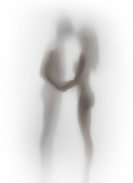 Beautiful kissing couple body shape silhouette can be seen through a diffuse curtain. - Фото, изображение