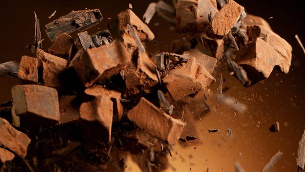 Flying pieces of crushed chocolate pieces - 写真・画像