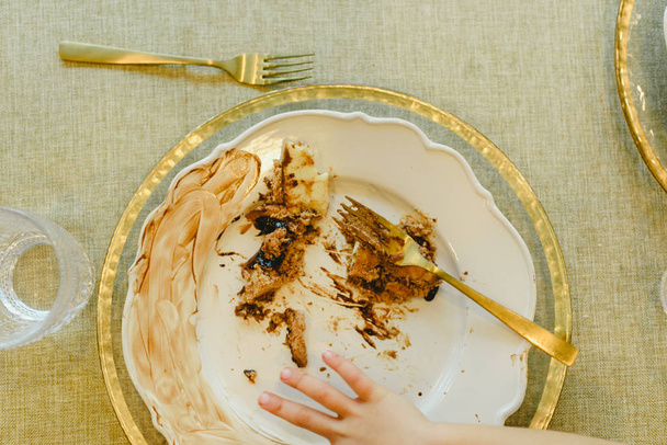 Elegant dish soiled and finished with child's hands finishing ea - Photo, Image