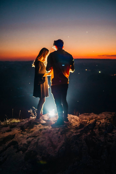 um casal acima da cidade da noite
 - Foto, Imagem