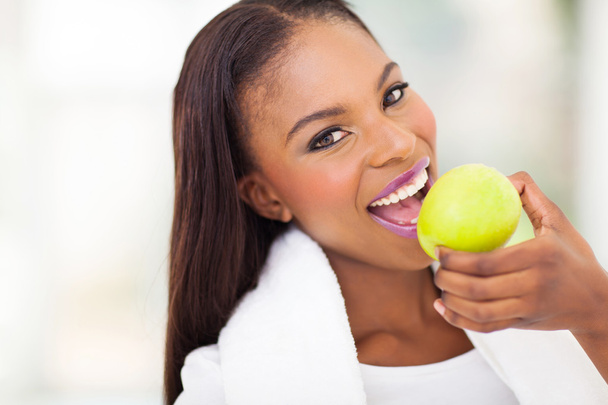 african woman eating apple - Photo, image