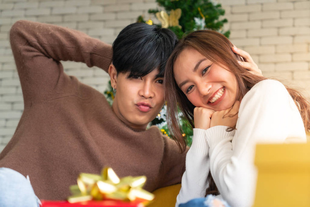 Portrait of couple celebrating Christmas festival holiday in living room with Christmas decoration Ornamental - 写真・画像