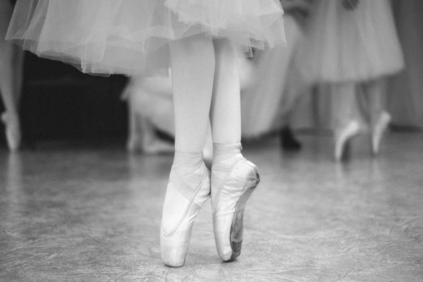 ダンスホールでトウシューズのバレリーナの足のクローズ アップ。ビンテージ写真.  - 写真・画像