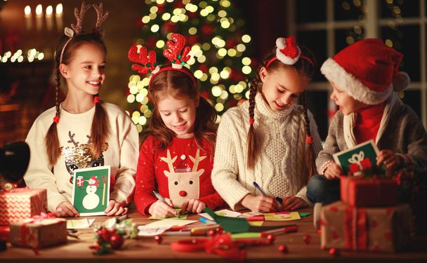 happy friends kids draw decorations and write  letter to Santa n - Foto, imagen