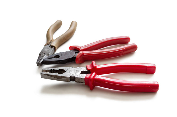 Three pliers with insulating handles, on a white background - Photo, Image