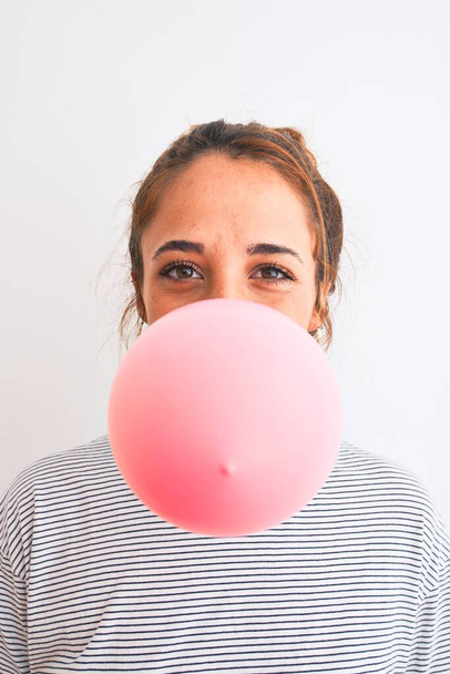 Jonge readhead moderne vrouw kauwgom kauwen en doen luchtbel - Foto, afbeelding