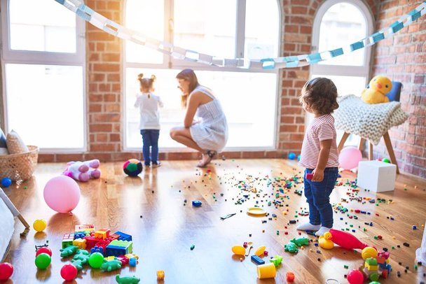 Young beautiful teacher and toddlers playing at kindergarten - Foto, immagini