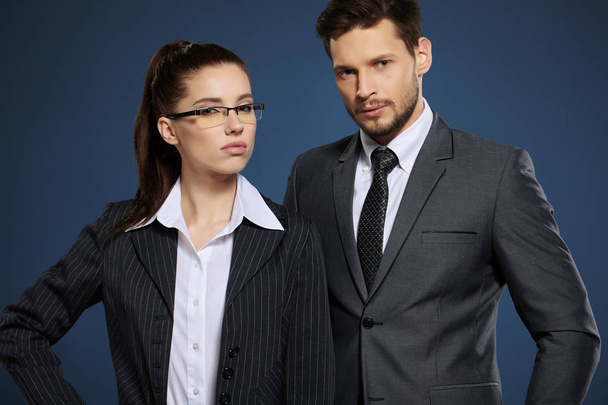 Business couple on blue background - Фото, изображение