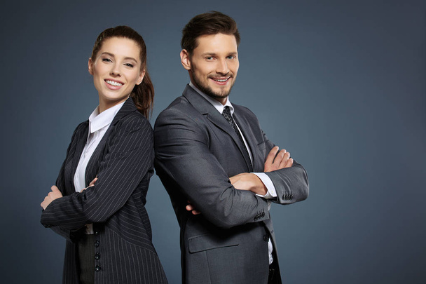 Business couple on blue background - Foto, afbeelding