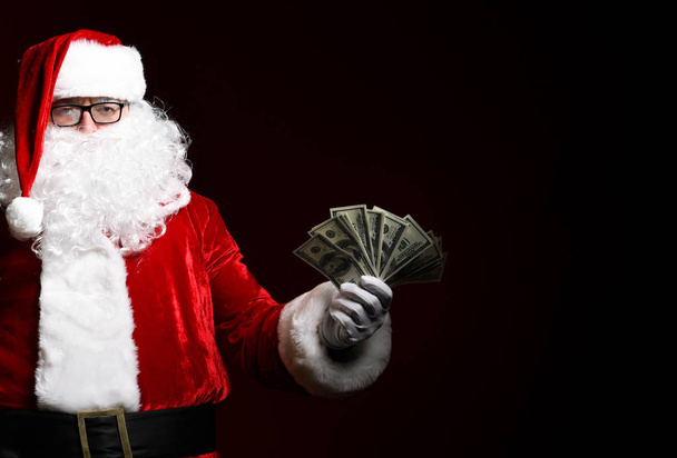 Photo of happy Santa Claus with dollar bills looking at camera - Photo, Image