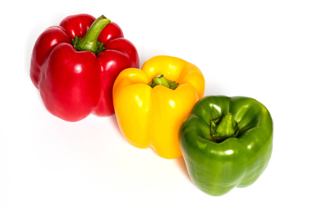 Three Red, Yellow, Green Peppers isolated on white background. - Фото, зображення