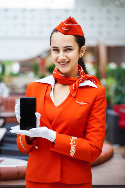 RUSSIA, MOSCOW: 01 AUGUST 2019. Beautiful stewardess dressed in  - Photo, image