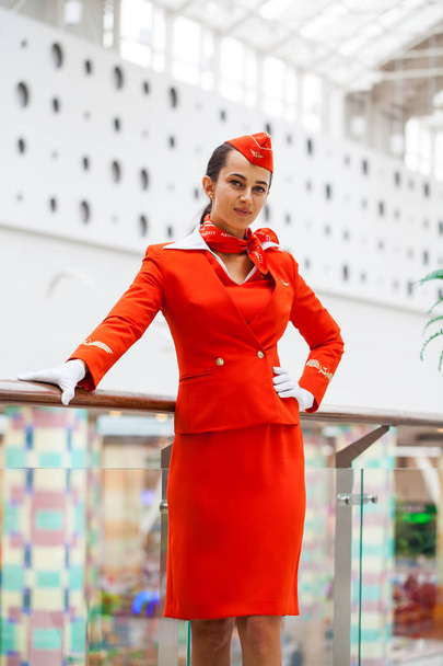 RUSSIA, MOSCOW: 01 AUGUST 2019. Beautiful stewardess dressed in  - Zdjęcie, obraz