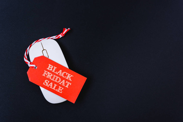 Online shopping Black Friday sale text red tag on white mouse - Valokuva, kuva