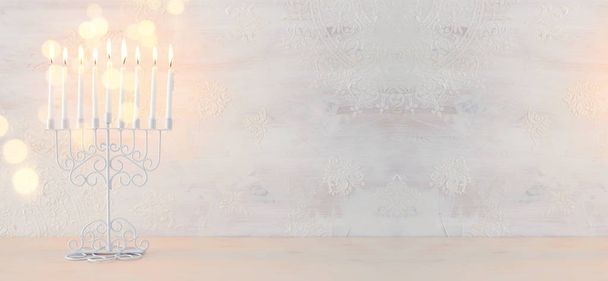 Religion image of jewish holiday Hanukkah background with menorah (traditional candelabra) and candles over white background - Foto, Imagen